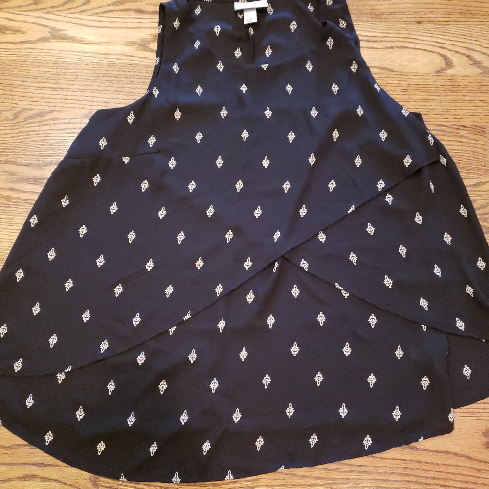 Black top with leaf pattern and asymmetrical cut